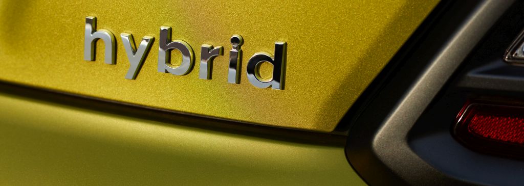 Chromed hybrid car logo on green background